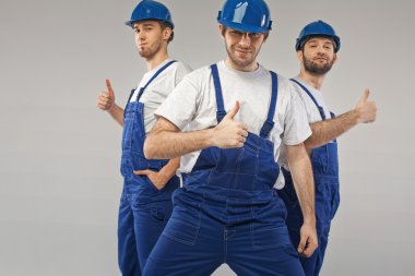 Three optimistic employees during the work