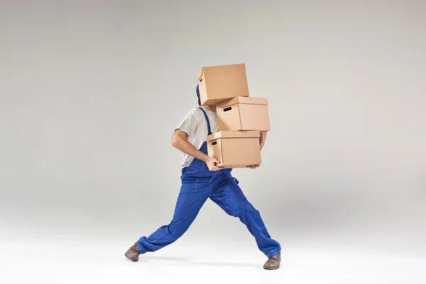 Hard-working builder holding paper boxes — Stock Photo, Image