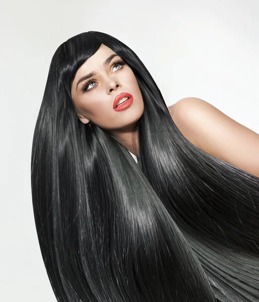 Portrait of a woman with long. straight and bushy hair Stock Picture