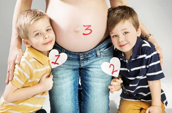 Pregnant mother posing with happy children Royalty Free Stock Photos