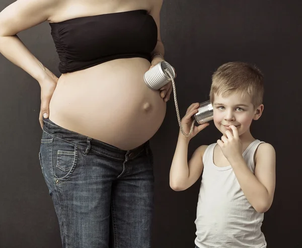 Little boy talking to the unborn sibling — Stock Photo, Image