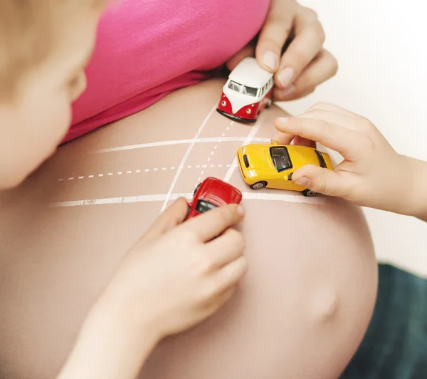 Brothers playing with their unborn sibling — Stock Photo, Image