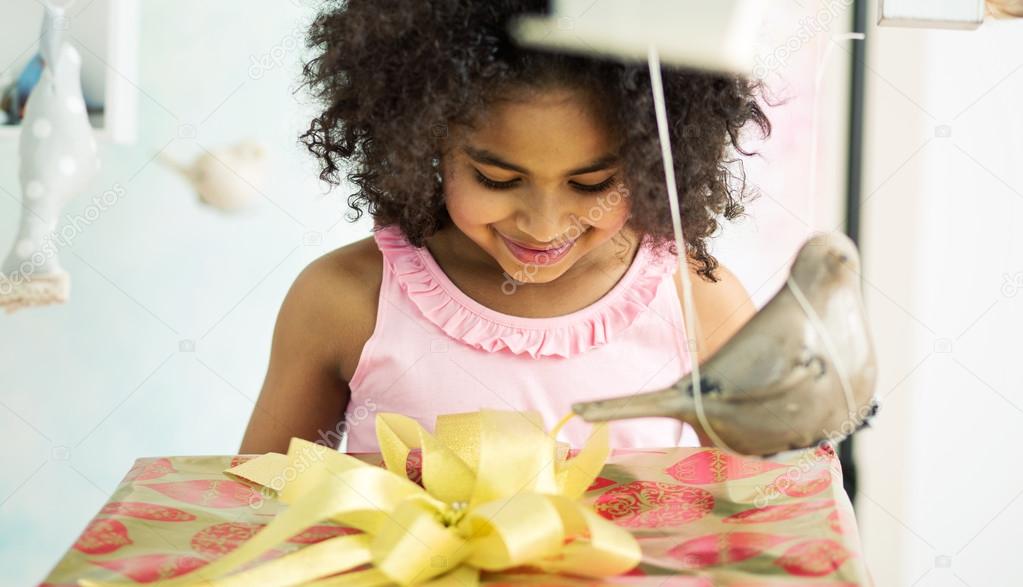 Adorable girl opening the birthday gift