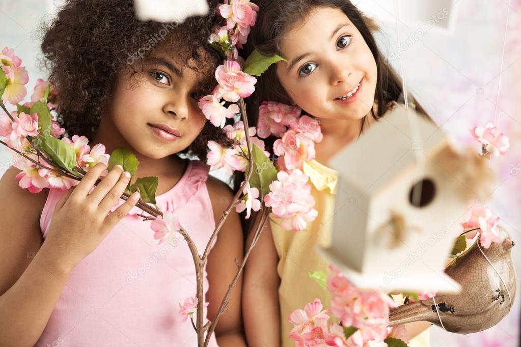 Two cute girls with pink flowers