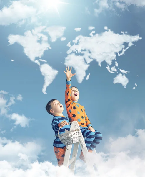 Two boys touching a world map — Stock Photo, Image