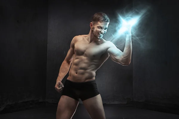 Muscular guy squeezing the power — Stock Photo, Image