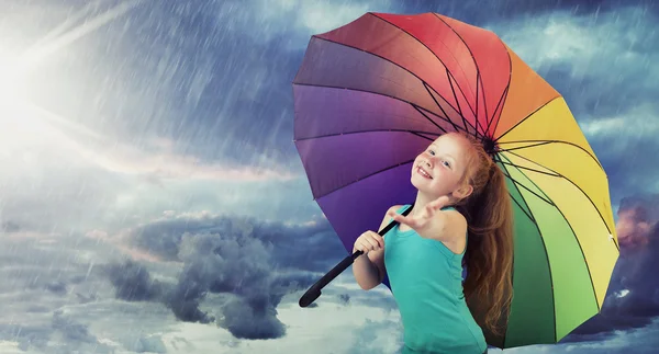 Cheerful girl with a colorful umbrella — Stock Photo, Image