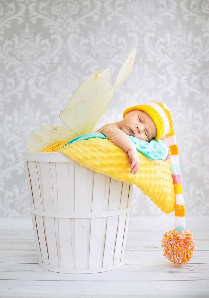 Little boy sleeping in the wicker basket