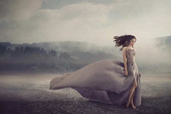 Sensual woman walking on the fantasy ground — Stock Photo, Image