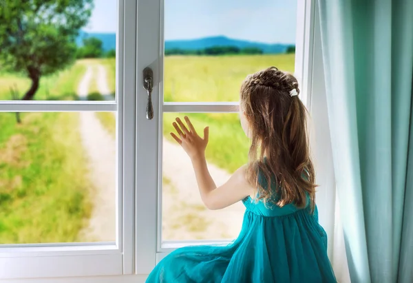 Sad girl looking through window — Stock Photo, Image