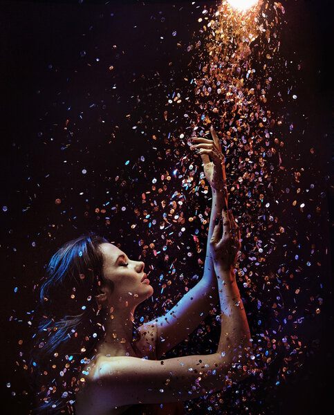 Conceptual picture of a woman among pieces of crystal