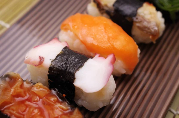 Sushi nigiri in dish with bamboo sticks — Stock Photo, Image