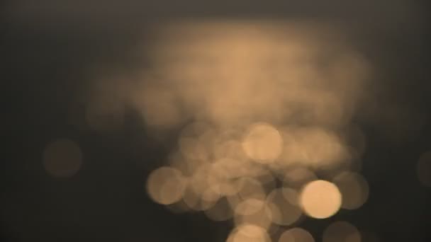 Bokeh of sunset light reflect on wave at sea (Blurred background) — Stock Video