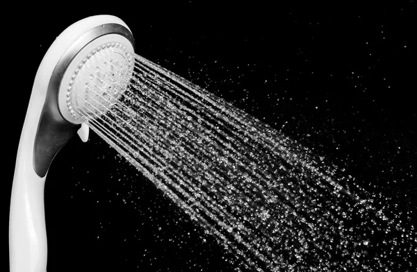 Modern shower head with running water isolated on black backgrou — Stock Photo, Image