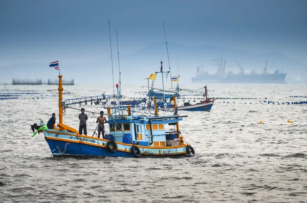 Fisherman with boat in sea — Stock Fotó