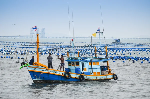 Fisherman with boat in sea — Stock Photo, Image