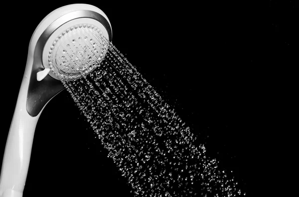 Modern shower head with running water isolated on black backgrou — Stock Photo, Image