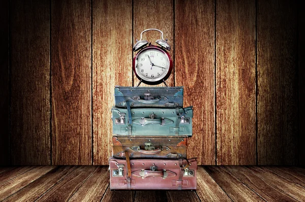Time to travel concept, Baggage and alarm clock on wooden floor — Stock Photo, Image