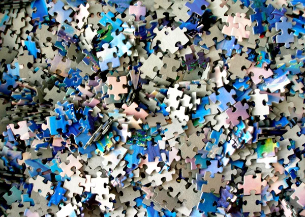 Molte parti di un puzzle Immagine Stock