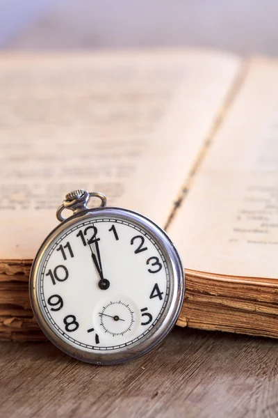 Pocket watch next to book — Stock Photo, Image