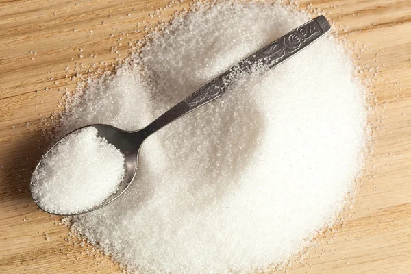 Spoon in a pile of sugar — Stock Photo, Image