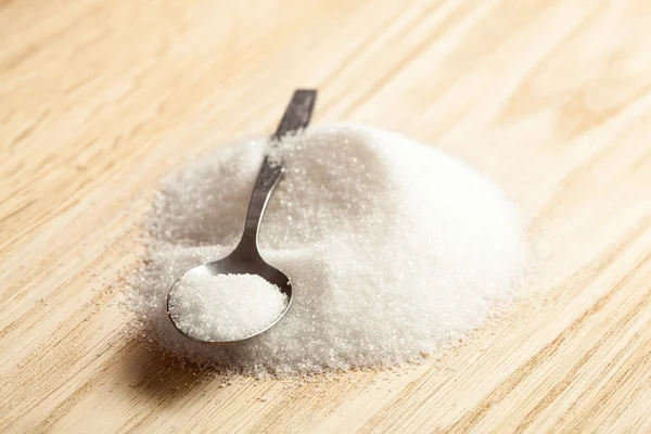 Spoon in a pile of sugar — Stock Photo, Image