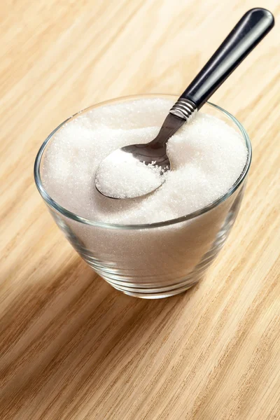 Spoon in a bowl of sugar — Stock Photo, Image