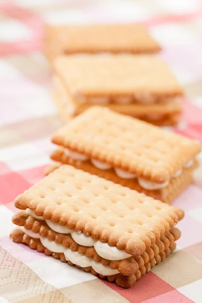 Sandwich cookies on pink tablecloth — Stock Photo, Image