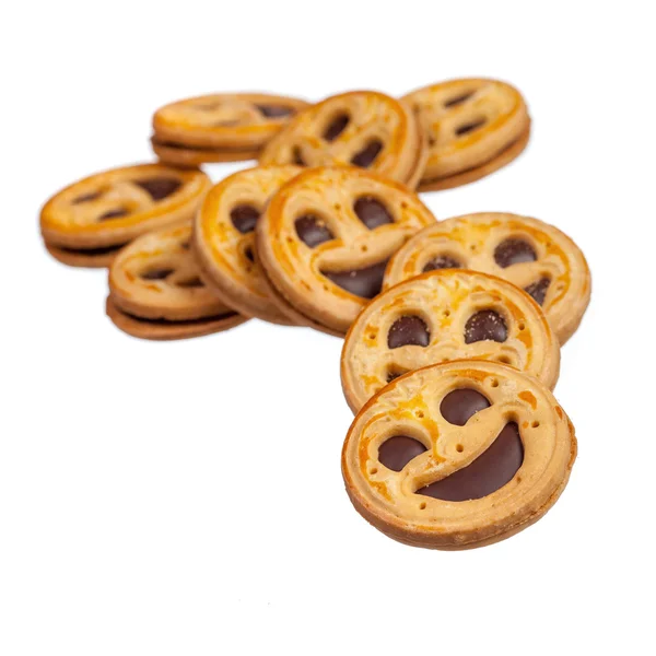 Runde Kekse mit lächelnden Gesichtern über weißen — Stockfoto