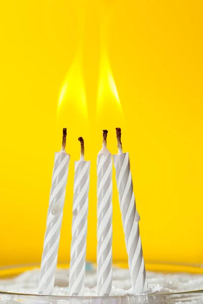 Burning white candles over yellow background — Stock Photo, Image