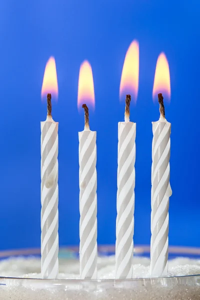 Burning white candles over blue background — Stock Photo, Image