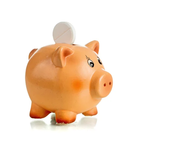 Piggy bank met witte tablet op de achterkant — Stockfoto