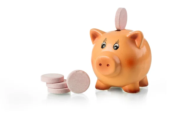 Piggy bank with pink tablet on the back — Stock Photo, Image