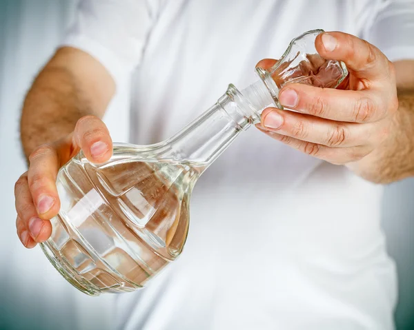 Carafe in hands — Stock Photo, Image