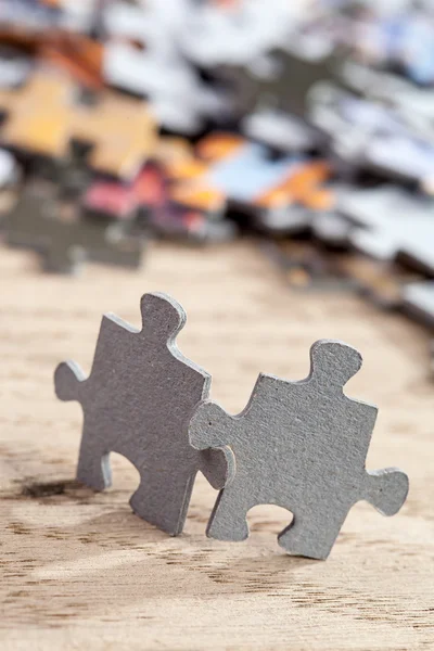 Two Jigsaw Puzzle Pieces on Table — Stock Photo, Image