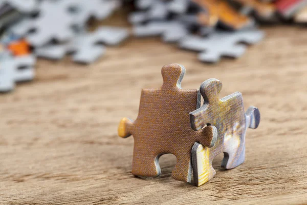 Two Jigsaw Puzzle Pieces on Table — Stock Photo, Image