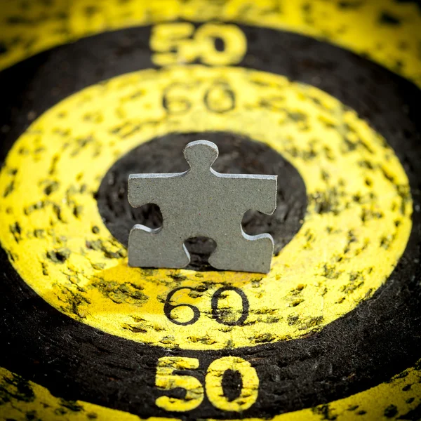 Jigsaw Puzzle Piece on Old Target — Stock Photo, Image