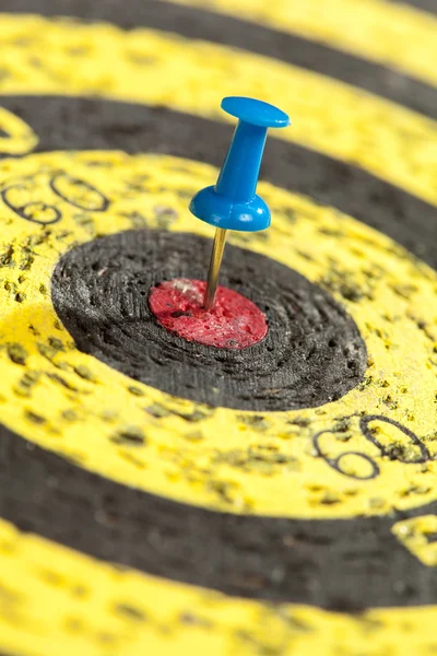 Blue Pin Stuck in an Old Yellow Target — Stock Photo, Image