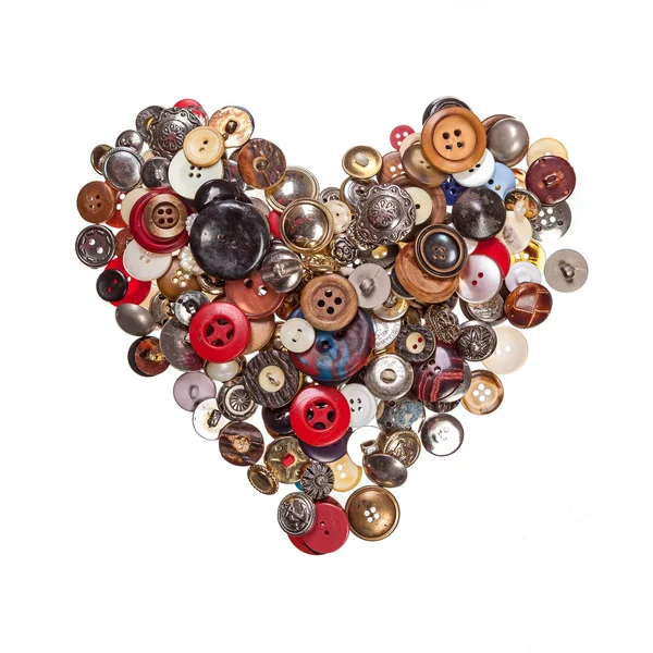 Sewing buttons in shape of heart Stock Picture