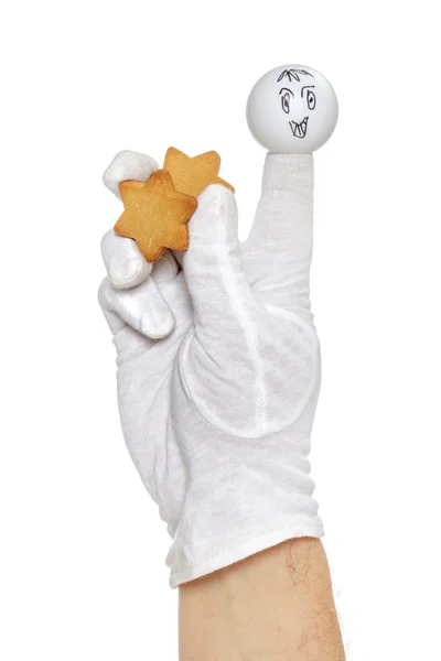 Finger puppet holding gingerbread star — Stock Photo, Image