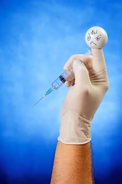 Angry finger puppet with syringe — Stock Photo, Image