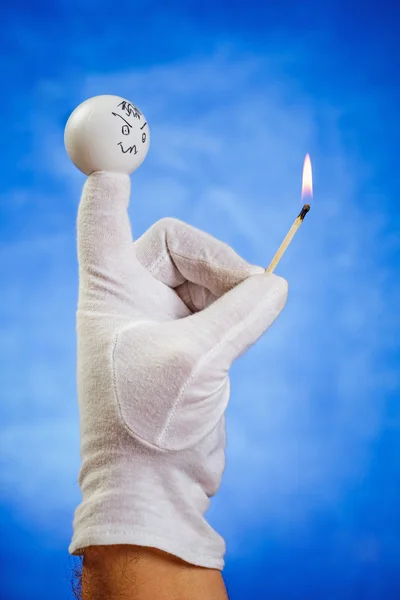 Burning matchstick hold by angry finger puppet — Stock Photo, Image