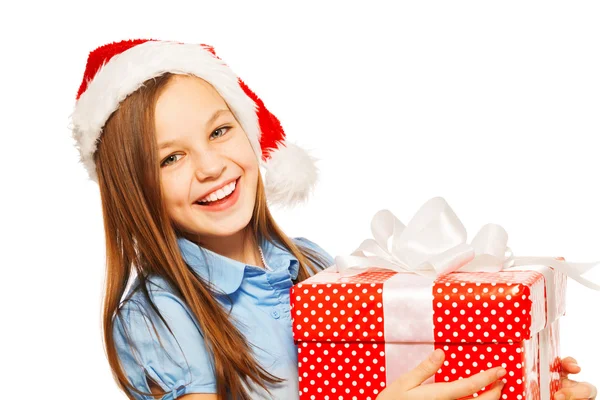 Portrait of a girl in Santa hat with present — Stock Photo, Image