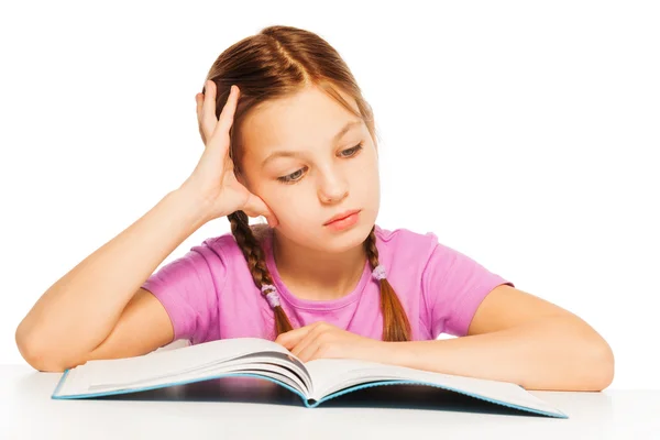 Schoolgirl is reading interesting book — Stock Photo, Image