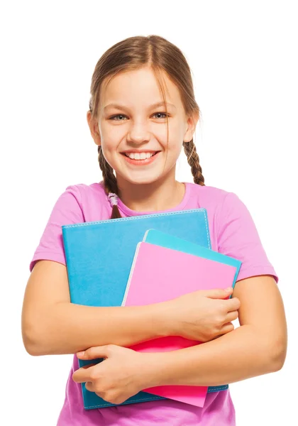 Schoolmeisje staande met haar schoolboeken — Stockfoto