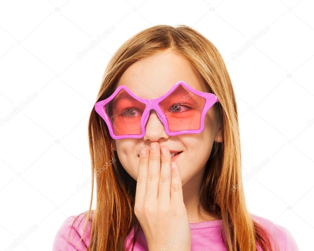 Funny giggling girl in glasses with star frames