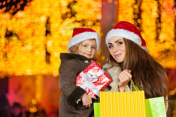 Mother and daughter with holiday presents — Stock Photo, Image