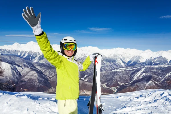 Skier woman wave hand and hold ski — Stock Photo, Image