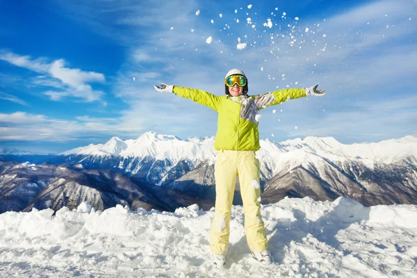 Happy skier woman throwing snow up Stock Photo