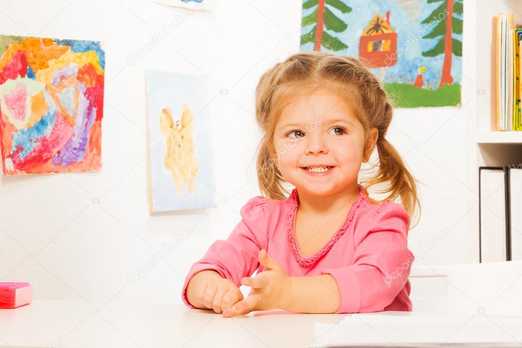 Cute little girl doing her lessons at the desk